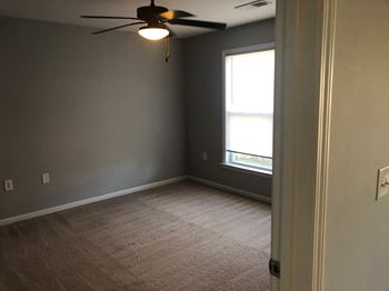 Room with a ceiling fan and a window.